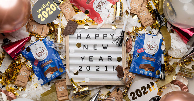 A signboard with 'Happy New Year 2021' written on it, surrounded by ChocZero chocolate